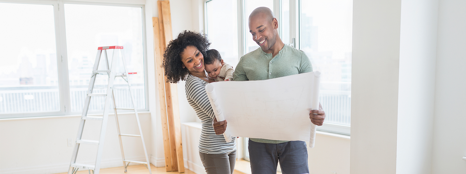 A couple looks at the blueprints for their new home.