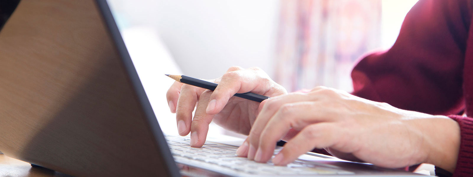 Woman typing on her laptop.